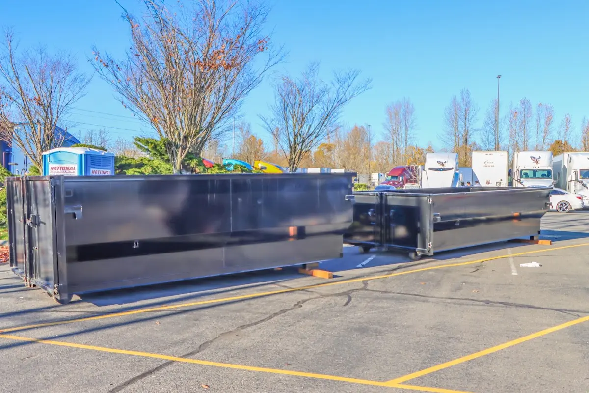 Professional dumpster rental service with roll-off container on residential driveway in South Sioux City